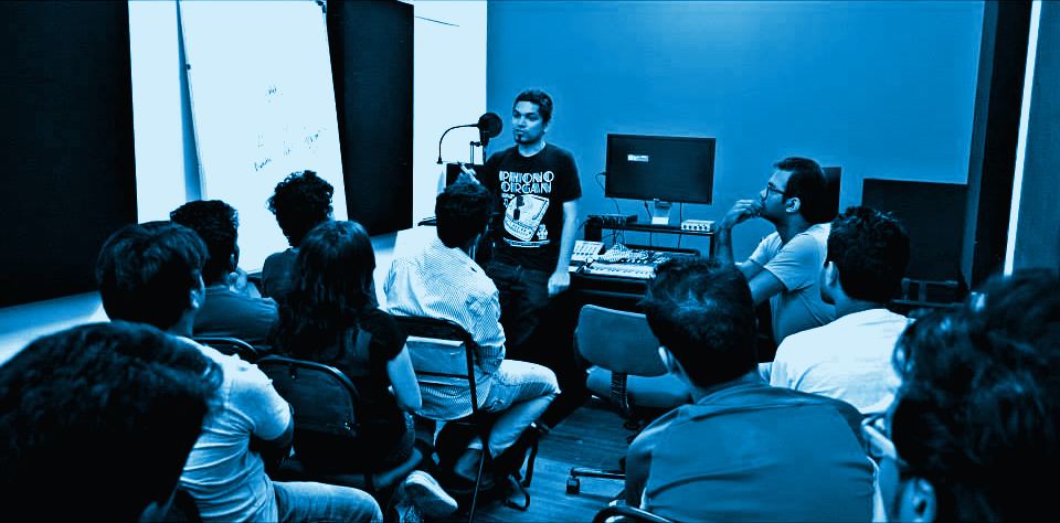 A full room of students facing the front during the Bharat Goel masterclass