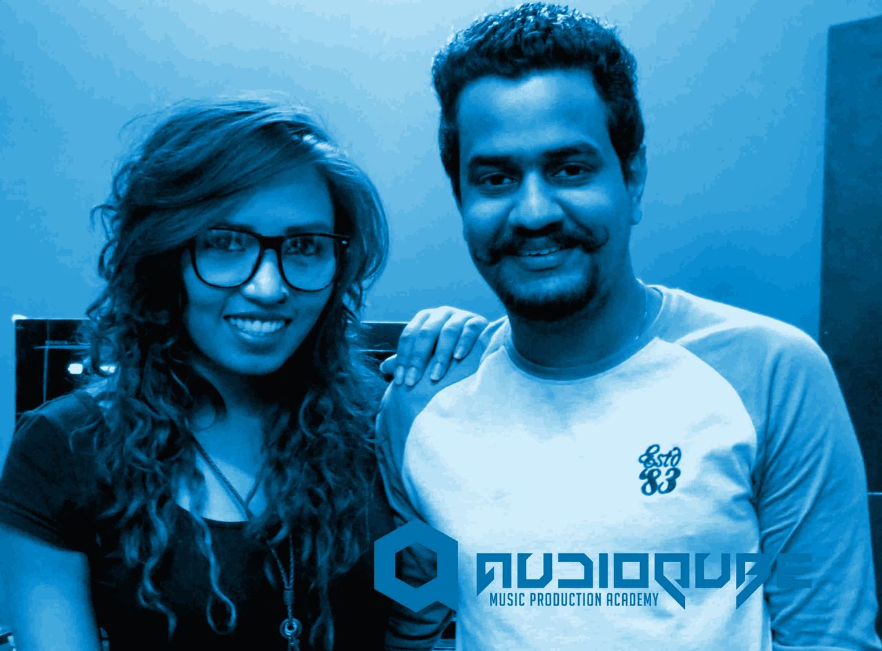 Audioqube DJ faculty posing with Sound Avtar in front of the Audioqube logo